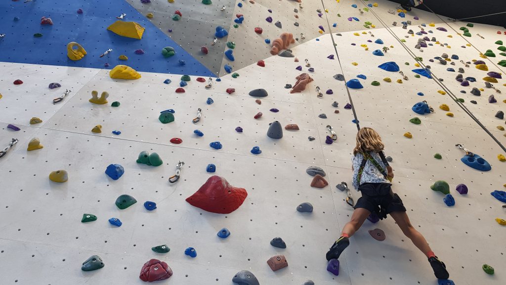 Altitude Summer Camps Blog - girl climbing up a climbing wall