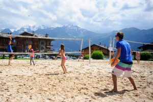 Residential camps - kids playing volleyball in Swiss mountains
