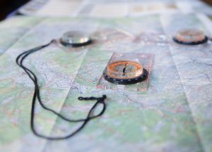 Altitude Camps - maps and compasses on a table