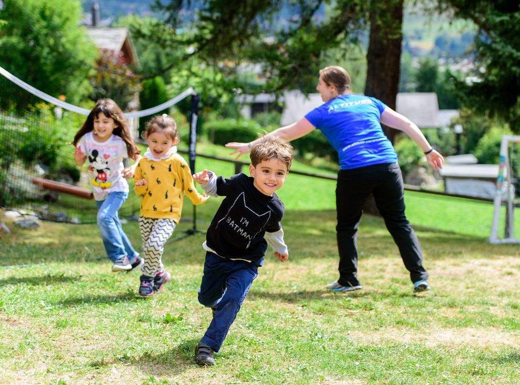 International Kids Camp - Kids running in the garden