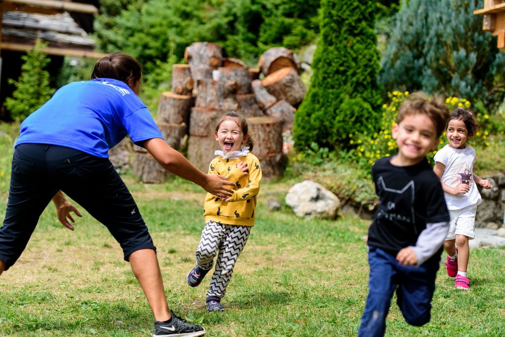 Pre-school age children playing in garden at Switzerland summer camp