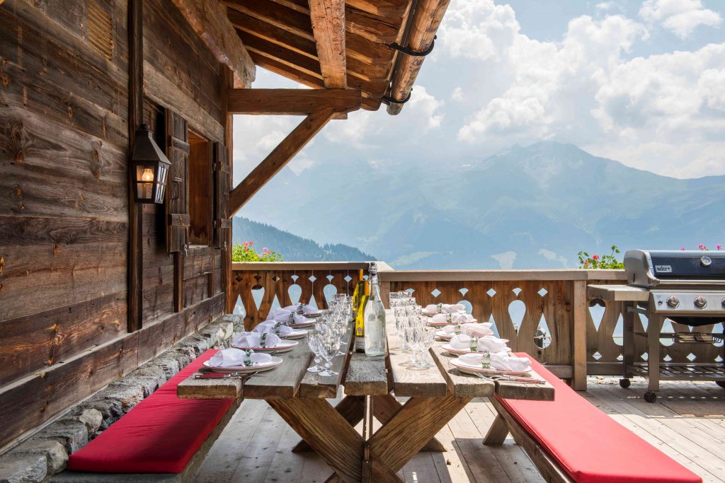 Outdoor dining on terrace of luxury Verbier chalet