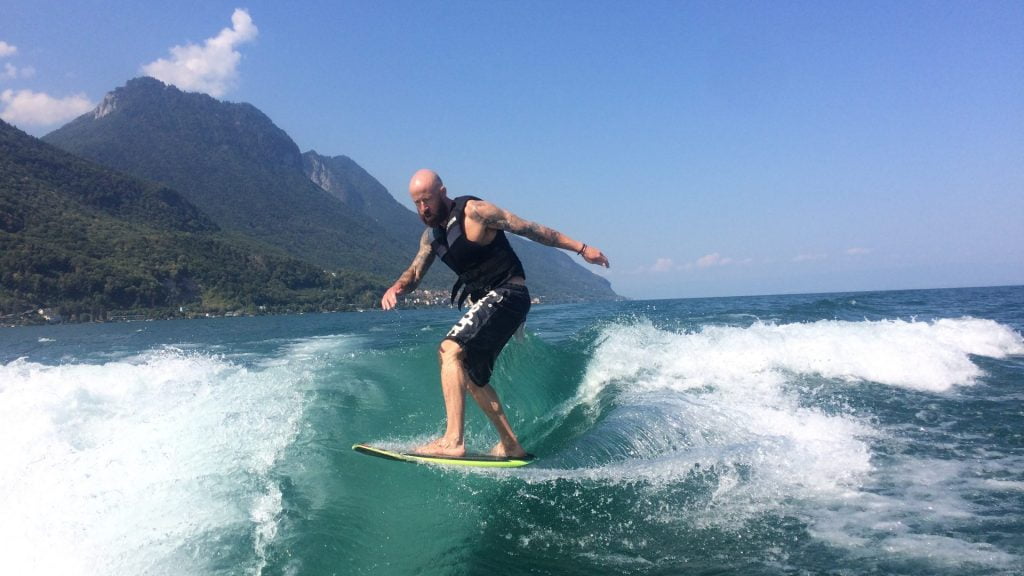 Man surfing wake, lake Geneva