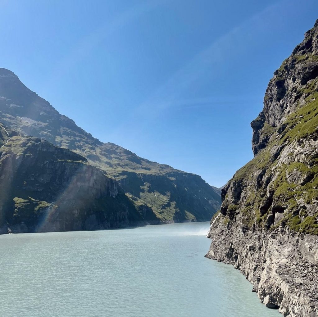 Mountains going into the turquoise blue waters of Mauvoisin Dam